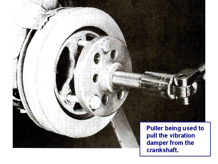 Puller being used to pull the vibration damper from the crankshaft. 