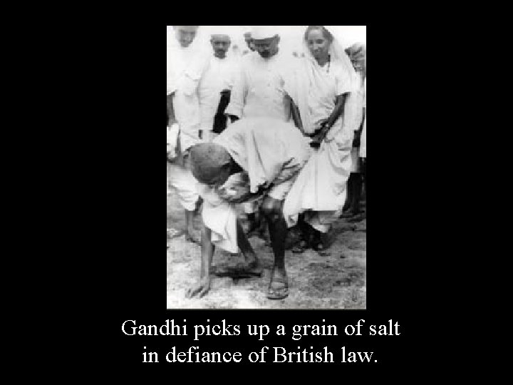 Gandhi picks up a grain of salt in defiance of British law. 