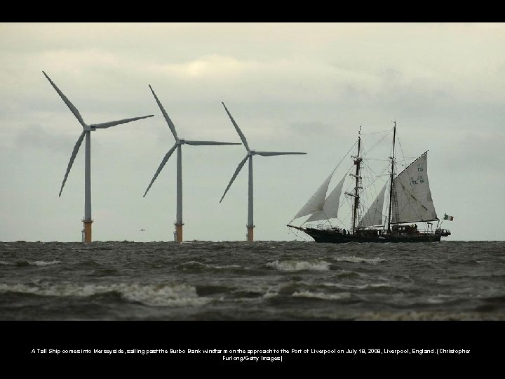 A Tall Ship comes into Merseyside, sailing past the Burbo Bank windfarm on the