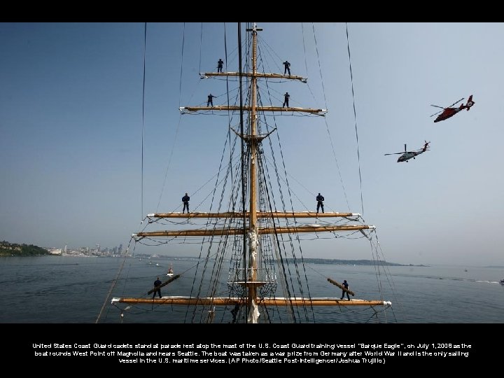 United States Coast Guard cadets stand at parade rest atop the mast of the