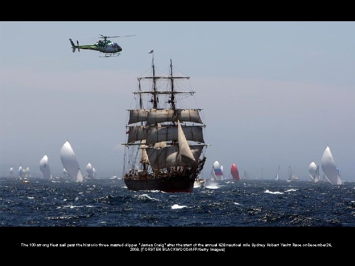 The 100 -strong fleet sail past the historic three-masted clipper "James Craig" after the