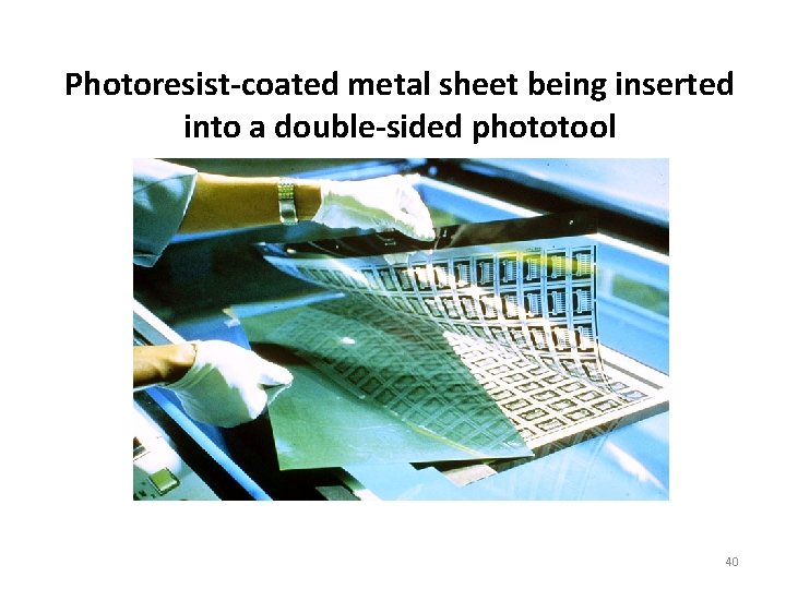 Photoresist-coated metal sheet being inserted into a double-sided phototool 40 