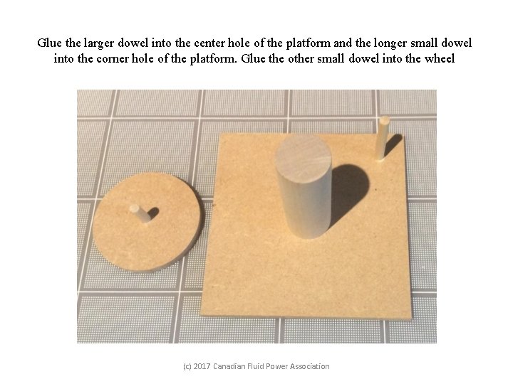 Glue the larger dowel into the center hole of the platform and the longer