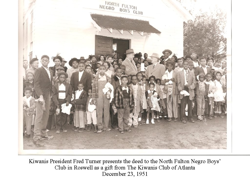 Kiwanis President Fred Turner presents the deed to the North Fulton Negro Boys’ Club