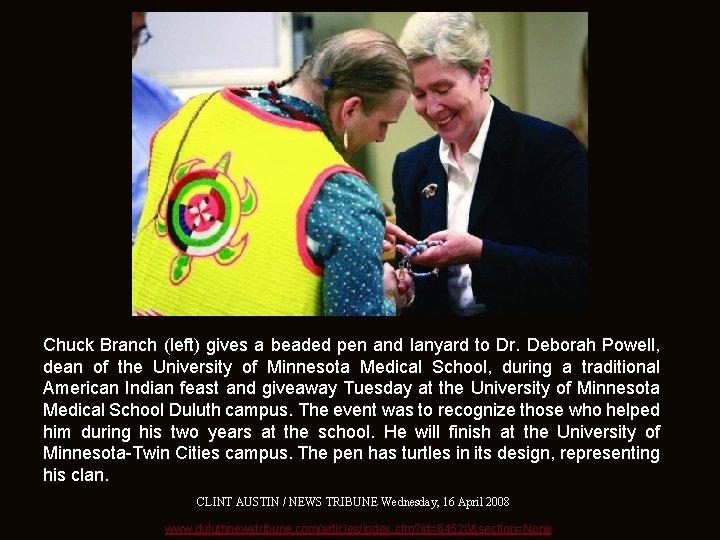 Chuck Branch (left) gives a beaded pen and lanyard to Dr. Deborah Powell, dean