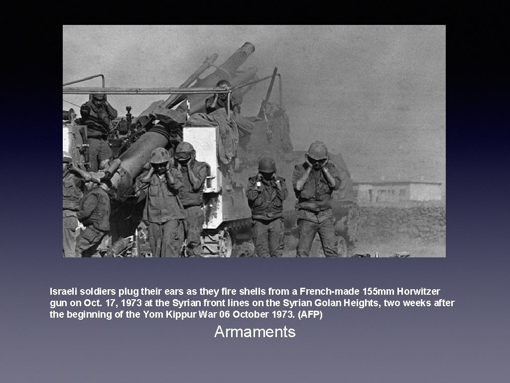 Israeli soldiers plug their ears as they fire shells from a French-made 155 mm