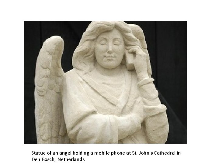 Statue of an angel holding a mobile phone at St. John's Cathedral in Den