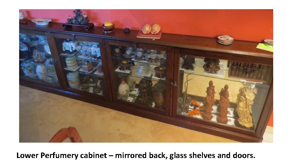 Lower Perfumery cabinet – mirrored back, glass shelves and doors. 