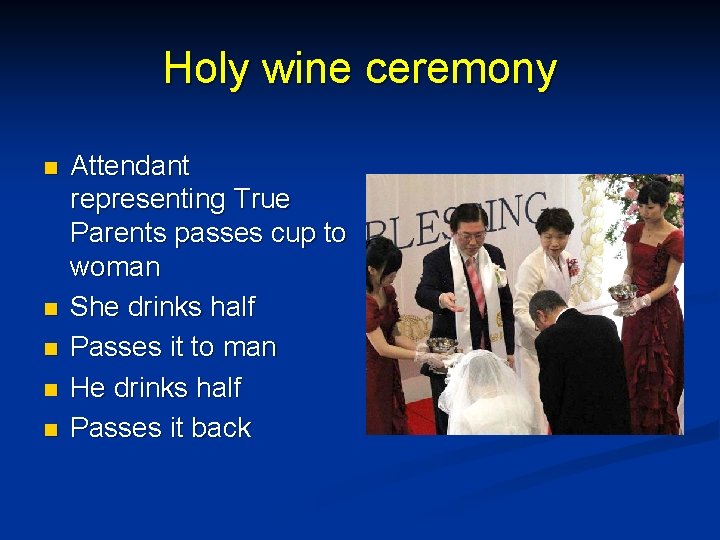 Holy wine ceremony n n n Attendant representing True Parents passes cup to woman