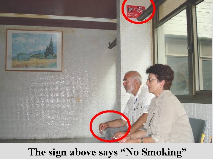 The sign above says “No Smoking” 