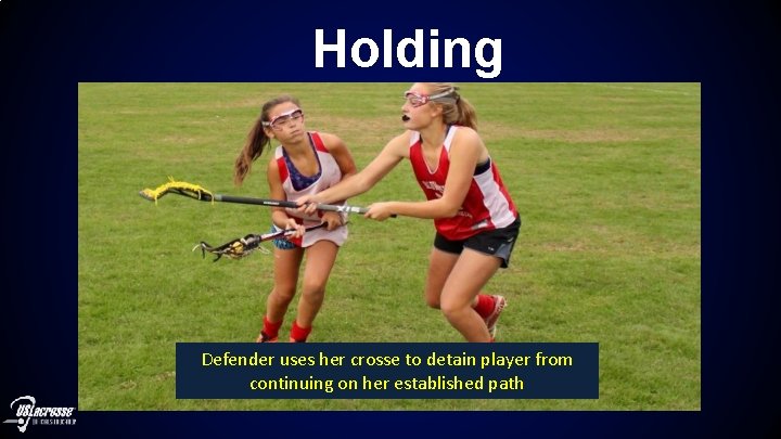 Holding Defender uses her crosse to detain player from continuing on her established path