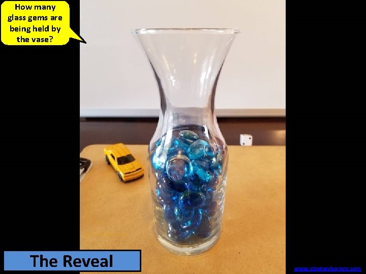 How many glass gems are being held by the vase? 69 The glass Reveal