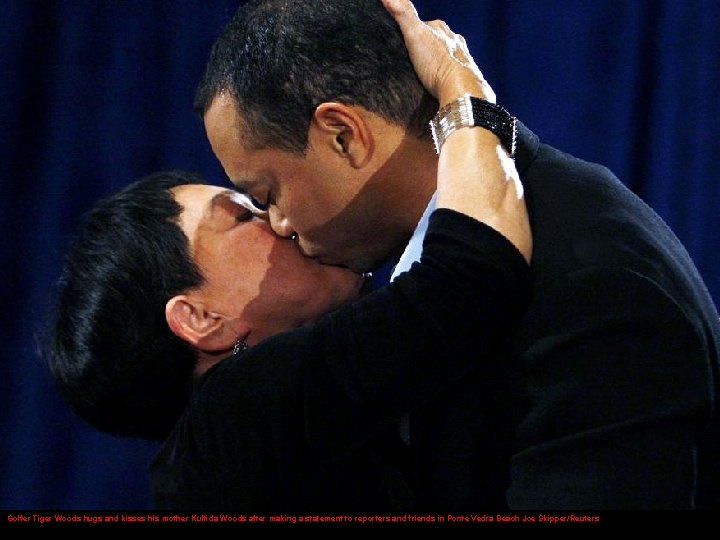 Golfer Tiger Woods hugs and kisses his mother Kultida Woods after making a statement