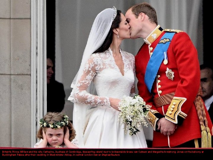 Britain's Prince William and his wife Catherine, Duchess of Cambridge, kiss as they stand