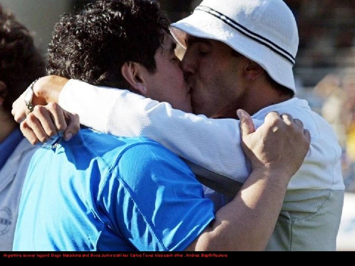 Argentine soccer legend Diego Maradona and Boca Juniors striker Carlos Tevez kiss each other.