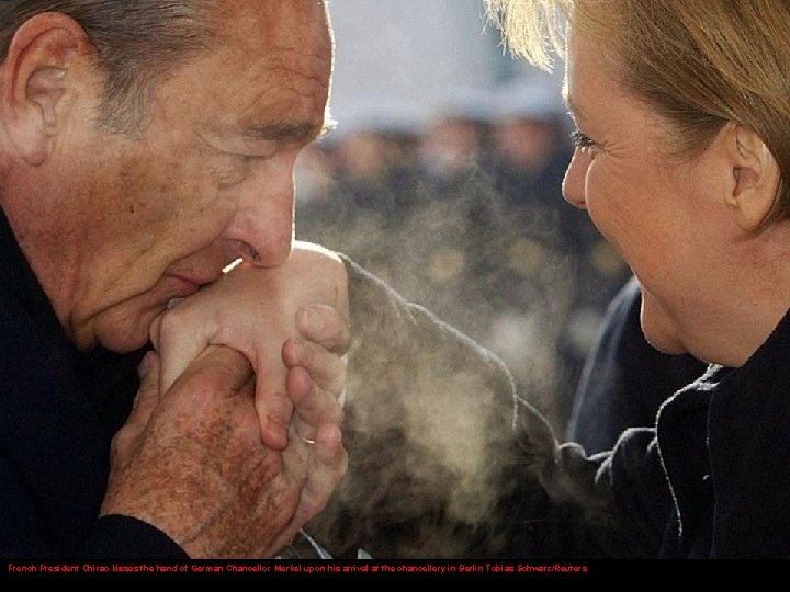 French President Chirac kisses the hand of German Chancellor Merkel upon his arrival at