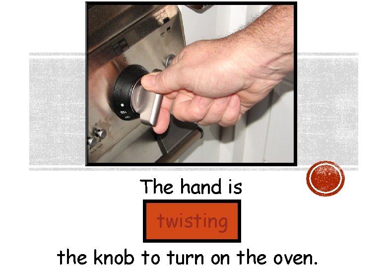 The hand is twisting the knob to turn on the oven. 