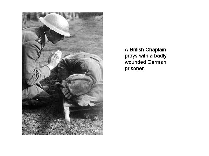 A British Chaplain prays with a badly wounded German prisoner. 