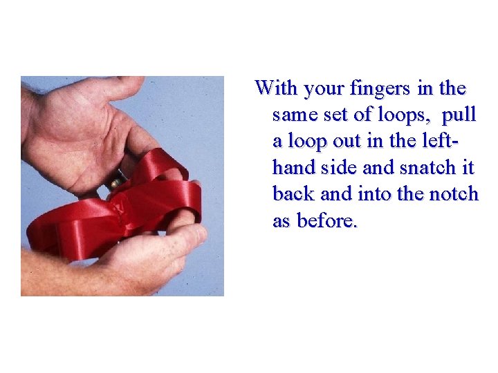 With your fingers in the same set of loops, pull a loop out in