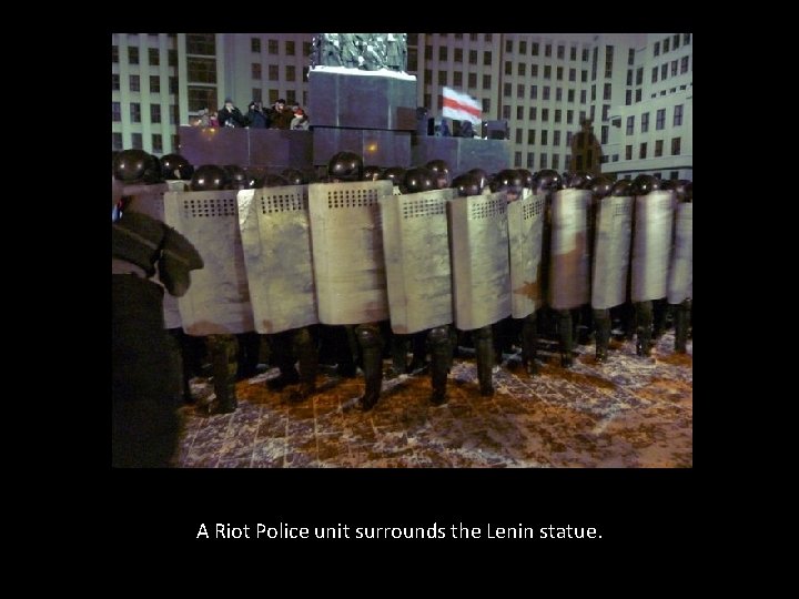 A Riot Police unit surrounds the Lenin statue. 