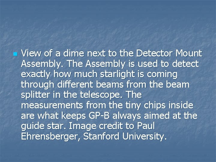 n View of a dime next to the Detector Mount Assembly. The Assembly is