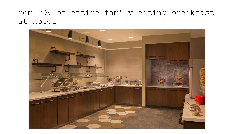 Mom POV of entire family eating breakfast at hotel. 