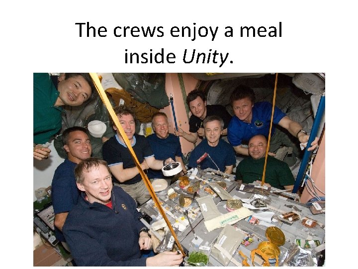 The crews enjoy a meal inside Unity. 