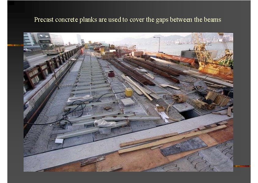 Precast concrete planks are used to cover the gaps between the beams 