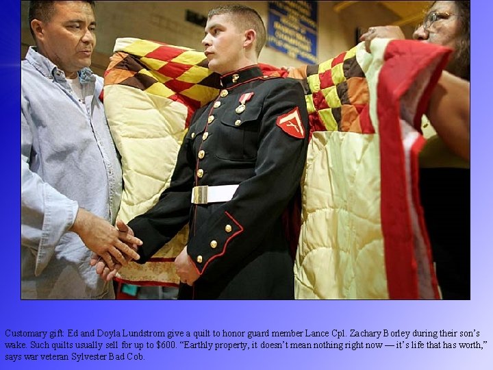 Customary gift: Ed and Doyla Lundstrom give a quilt to honor guard member Lance