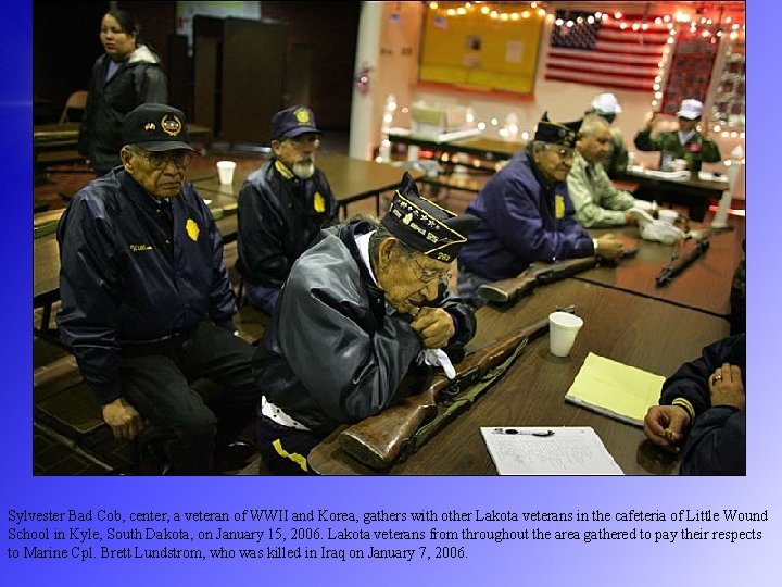 Sylvester Bad Cob, center, a veteran of WWII and Korea, gathers with other Lakota