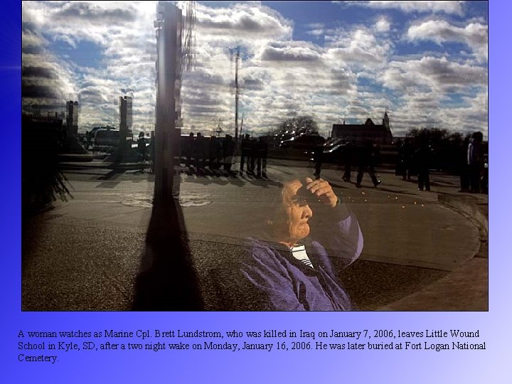 A woman watches as Marine Cpl. Brett Lundstrom, who was killed in Iraq on