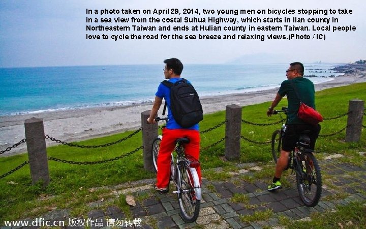In a photo taken on April 29, 2014, two young men on bicycles stopping