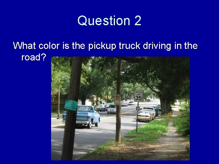 Question 2 What color is the pickup truck driving in the road? 