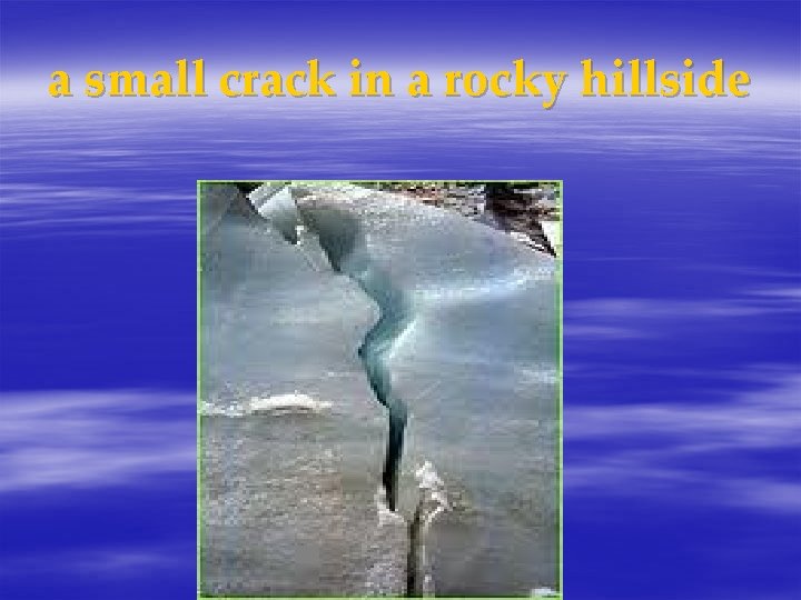 a small crack in a rocky hillside 