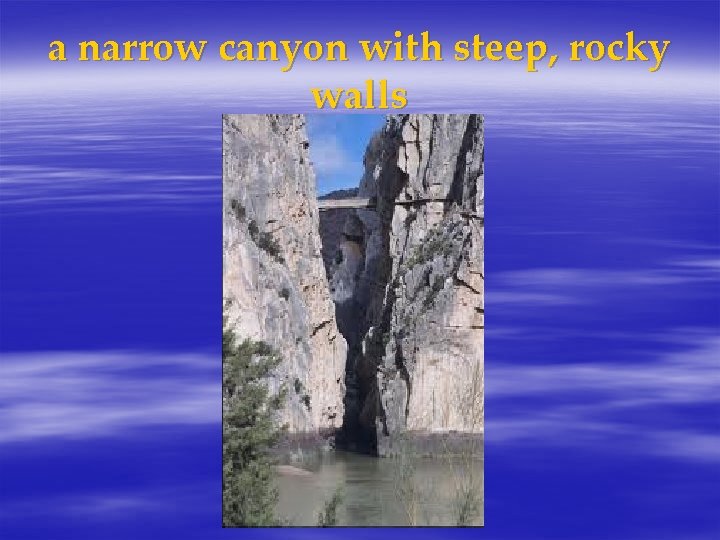 a narrow canyon with steep, rocky walls 