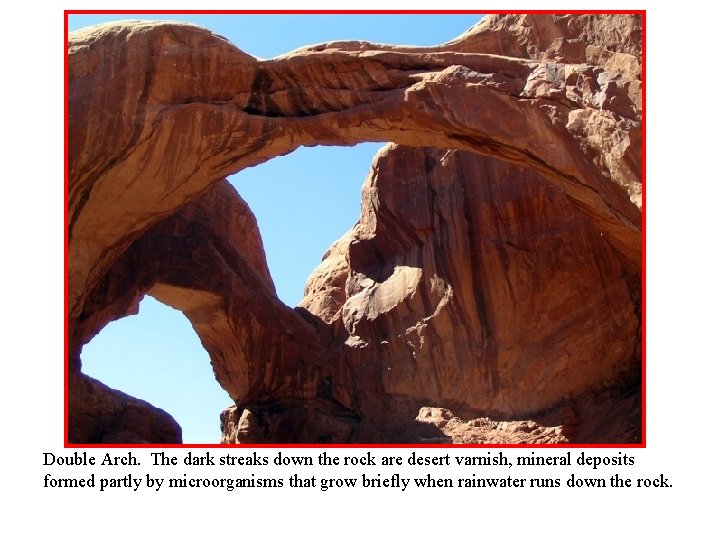 Double Arch. The dark streaks down the rock are desert varnish, mineral deposits formed