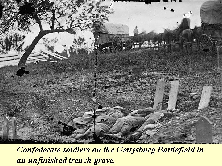 Confederate soldiers on the Gettysburg Battlefield in an unfinished trench grave. 