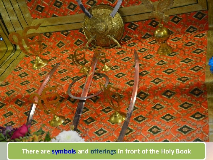 There are symbols and offerings in front of the Holy Book 