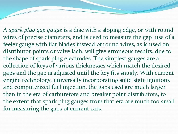 A spark plug gap gauge is a disc with a sloping edge, or with A spark plug gap gauge is a disc with a sloping edge, or with