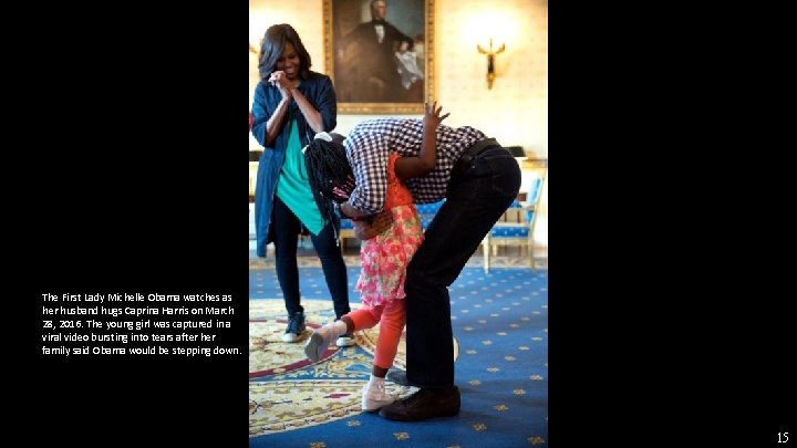 The First Lady Michelle Obama watches as her husband hugs Caprina Harris on March