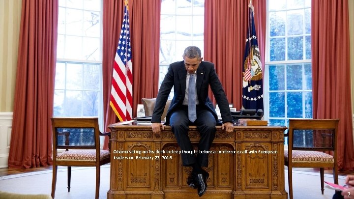 Obama sitting on his desk in deep thought before a conference call with European