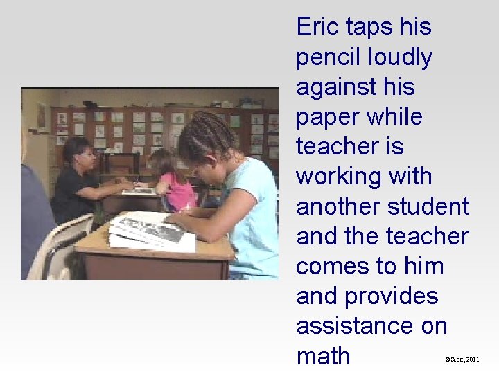Eric taps his pencil loudly against his paper while teacher is working with another