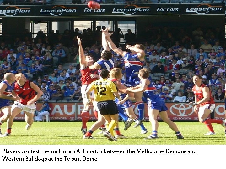 Players contest the ruck in an AFL match between the Melbourne Demons and Western