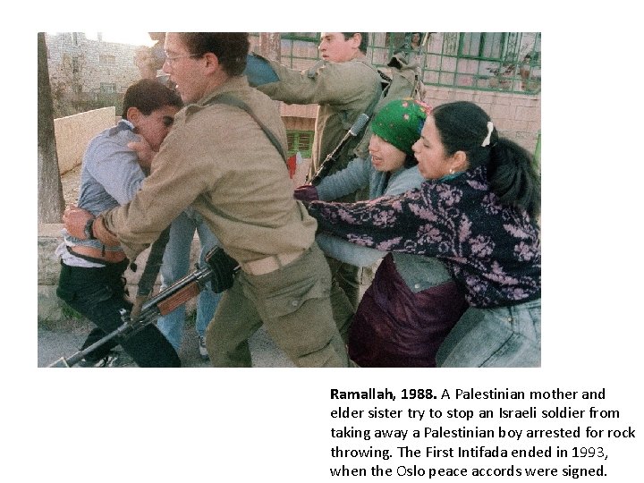 Ramallah, 1988. A Palestinian mother and elder sister try to stop an Israeli soldier