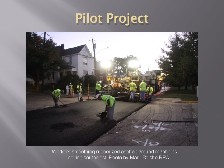 Pilot Project Workers smoothing rubberized asphalt around manholes looking southwest. Photo by Mark Belshe