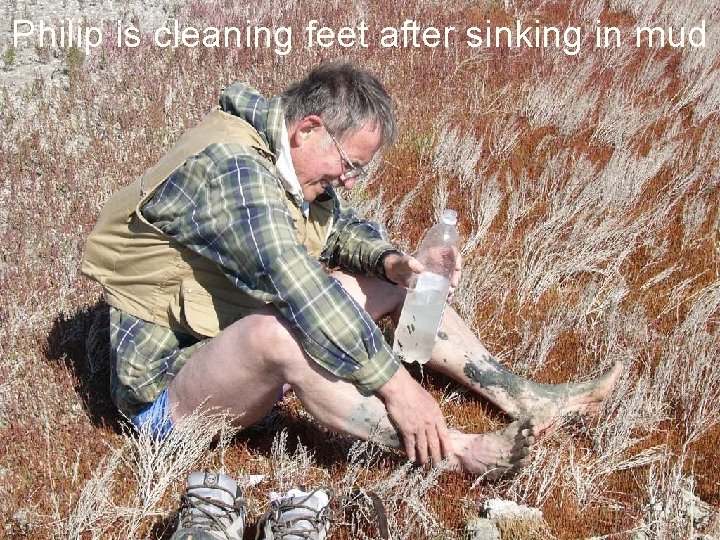 Philip is cleaning feet after sinking in mud 