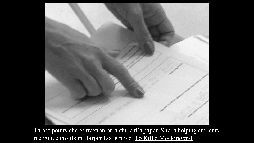 Talbot points at a correction on a student’s paper. She is helping students recognize