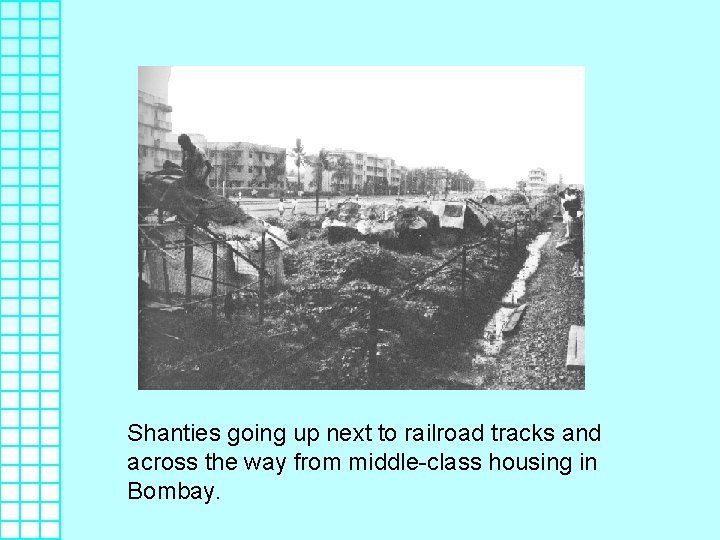 Shanties going up next to railroad tracks and across the way from middle-class housing