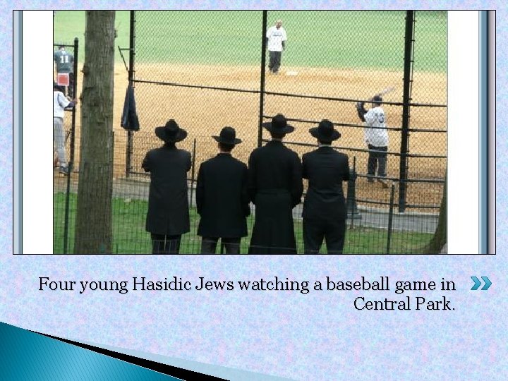 Four young Hasidic Jews watching a baseball game in Central Park. 