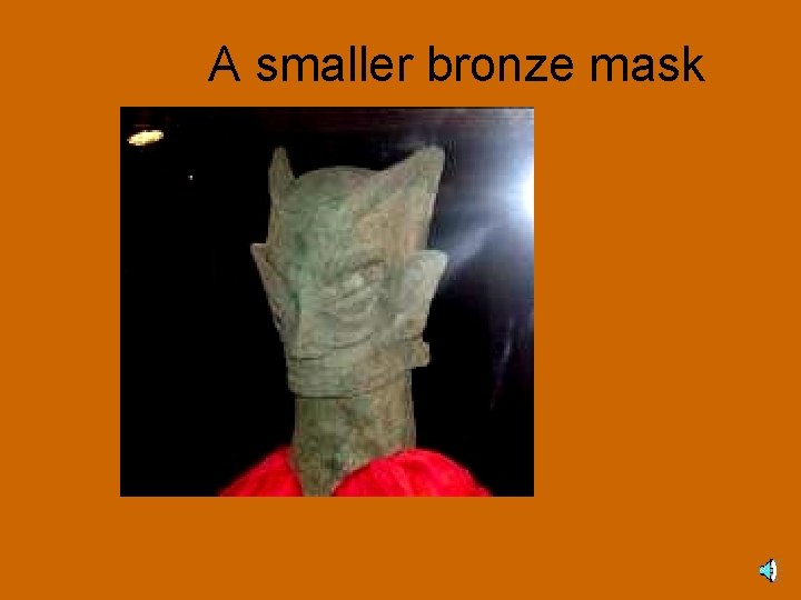 A smaller bronze mask 